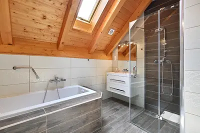 a bathroom with a tub and a glass shower at Relax Apartment in Prague