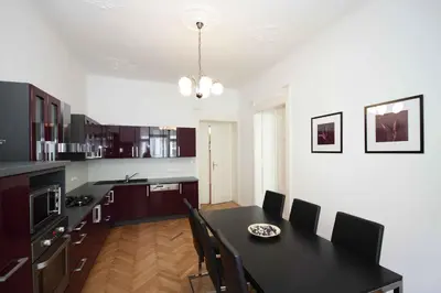 a kitchen with a black table and chairs at Prague Central Exclusive Apartments in Prague
