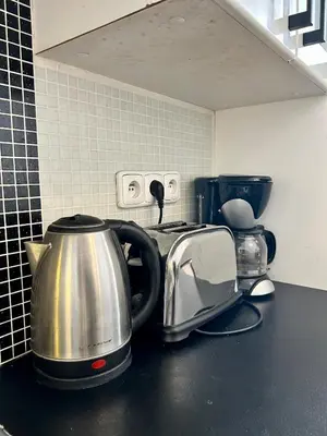 a kitchen counter with a tea kettle and toaster at Prague Central Exclusive Apartments in Prague