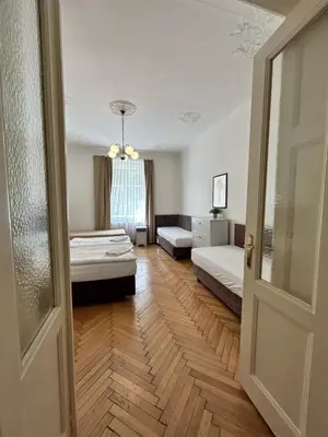 a room with two beds and a door at Prague Central Exclusive Apartments in Prague