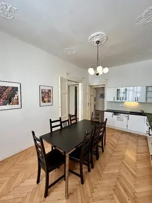 a dining room with a black table and chairs at Prague Central Exclusive Apartments in Prague