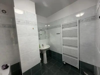 a white bathroom with a sink and a toilet at Prague Central Exclusive Apartments in Prague