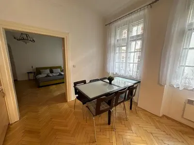 a bedroom with a dresser and a window at Nerudova Apartments in Prague
