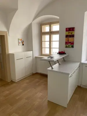 a dining room with a table and a couch in a room at Nerudova Apartments in Prague