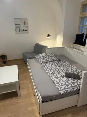 a bedroom with a bed with two brown shoes on it at Nerudova Apartments in Prague