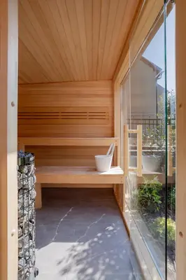 a sauna with a glass door in a house at Slapy Chata Hrdlička in Čím