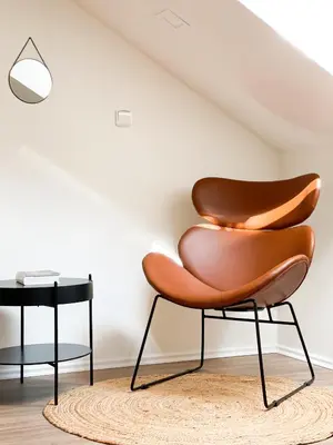 a chair and a side table in a room at Slapy Chata Hrdlička in Čím