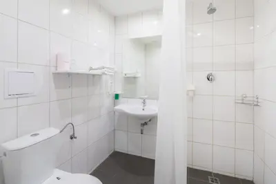 a white bathroom with a toilet and a sink at Minimino hotel in Prague