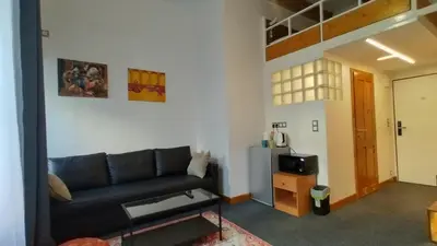 a living room with a couch and a tv at S42 Hotel Prague in Prague