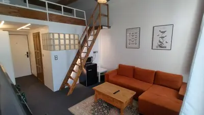 a living room with a loft bed and a couch at S42 Hotel Prague in Prague