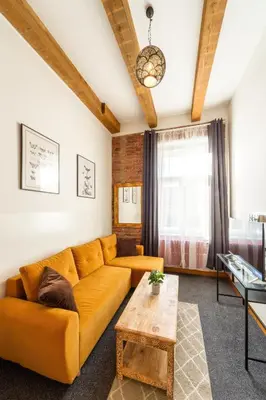 a living room with a couch and a table at S42 Hotel Prague in Prague