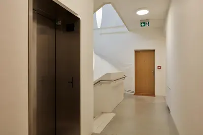 a hallway with a door and a staircase in a building at Prague Days - Premium Studios w Stunning Terraces - Easy City Access in Prague