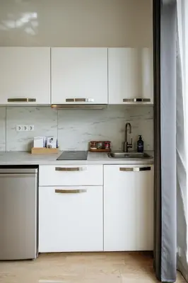 a kitchen with white cabinets and a sink at Prague Days - Premium Studios w Stunning Terraces - Easy City Access in Prague