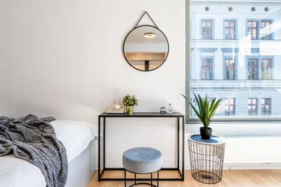 a bedroom with a bed and a mirror at Prague Days - Premium Studios w Stunning Terraces - Easy City Access in Prague