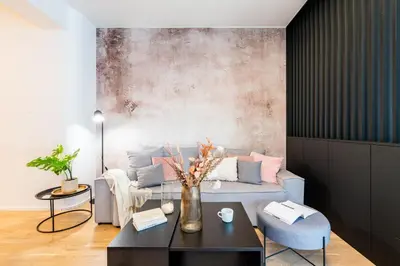 a living room with a couch and a table at Prague Days - Premium Studios w Stunning Terraces - Easy City Access in Prague
