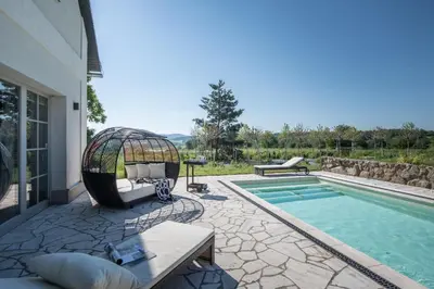 a backyard with a pool and a gazebo next to a house at Šťastná Samota in Vrchotovy Janovice