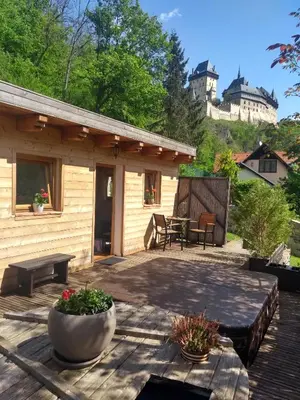 a patio with a house in the background at Stodola-soukromý apartmán pro dva s venkovní vířivkou in Karlštejn