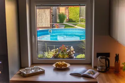 a window with a view of a swimming pool at Holiday House Adonis in Bystřice