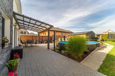 a patio with a swimming pool and a house at Holiday House Adonis in Bystřice