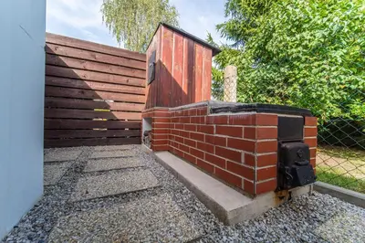 a brick wall with a door on the side of it at Holiday House Adonis in Bystřice