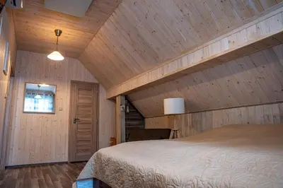 a bedroom with a bed and a chair at RelaxClub Kersko in Hradišťko