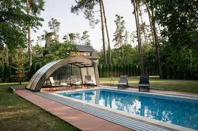 a house with a swimming pool in front of a house at RelaxClub Kersko in Hradišťko