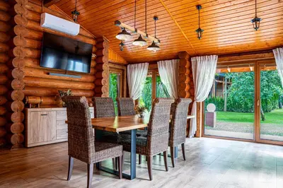 a dining room with a wooden table and chairs at RelaxClub Kersko in Hradišťko
