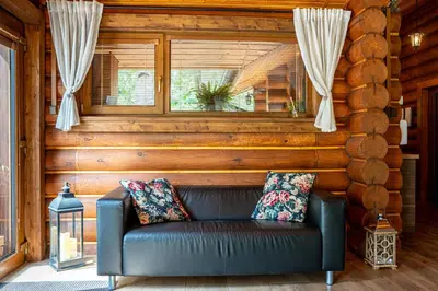 a leather couch in a room with a window at RelaxClub Kersko in Hradišťko