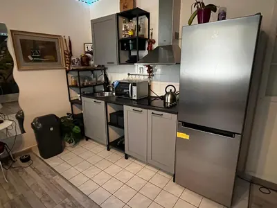 a kitchen with a stainless steel refrigerator and cabinets at MONFas APARTMENT PROVENCE IN PRAGUE in Prague