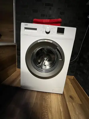 a washing machine with a red towel on top at MONFas APARTMENT PROVENCE IN PRAGUE in Prague