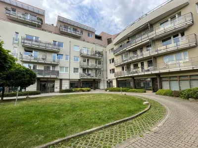 an apartment building with a lawn in front of it at MONFas APARTMENT PROVENCE IN PRAGUE in Prague