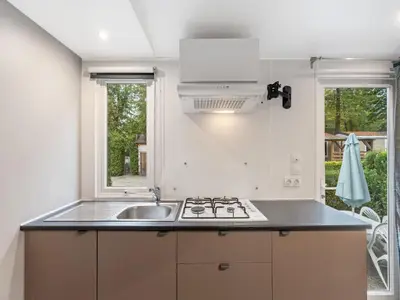 a kitchen with a sink and a stove and two windows at Holiday Home Florida by Interhome in Prague