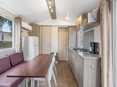a small kitchen with a wooden table and a refrigerator at Holiday Home Prima by Interhome in Prague