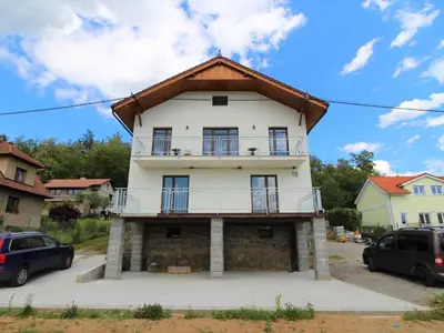 a large white house with a gambrel roof at Apartment Županovice-2 by Interhome in Dobříš