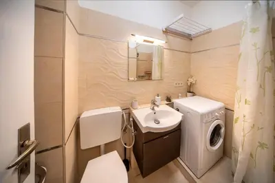 a hallway leading to a living room with a couch at Studio Apartment - Tower Petrin in Prague