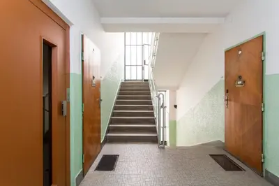 a long hallway with stairs in a building at Studio Apartment - Tower Petrin in Prague