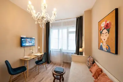 a living room with a couch and a chandelier at Studio Apartment - Tower Petrin in Prague