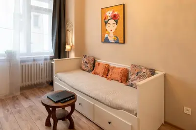 a couch in a room with a painting on the wall at Studio Apartment - Tower Petrin in Prague