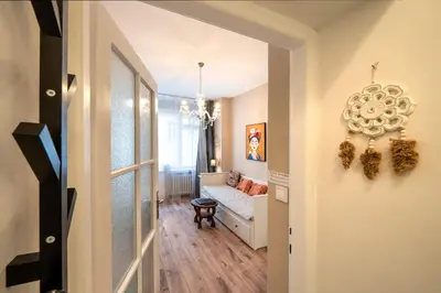a small table with two chairs and a tv on a wall at Studio Apartment - Tower Petrin in Prague