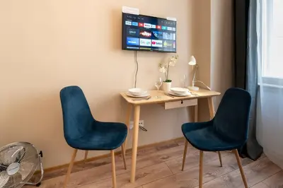 a living room with a couch and a painting on the wall at Studio Apartment - Tower Petrin in Prague