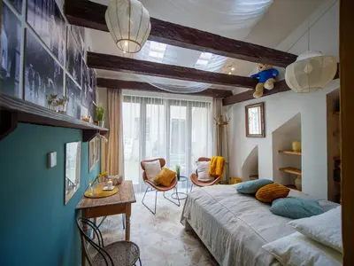 a bedroom with a bed and a table and chairs at Romantic nest under Prague Castle in Prague