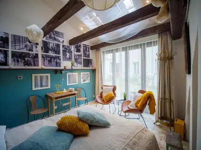 a bedroom with a bed and a table and chairs at Romantic nest under Prague Castle in Prague