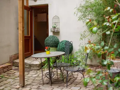 a patio with a table and chairs in front of a building at Romantic nest under Prague Castle in Prague