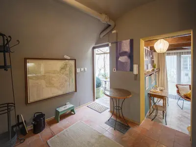 a living room with a table and chairs in it at Romantic nest under Prague Castle in Prague