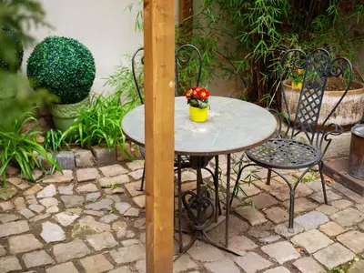 a table and two chairs with a flower pot on it at Romantic nest under Prague Castle in Prague