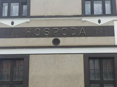 a building with a sign that reads hosocapo at Apartmán Měňany in Měňany