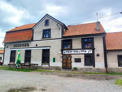 a building with a sign on the front of it at Apartmán Měňany in Měňany