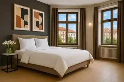 a bedroom with a large white bed and windows at Bohemian Dreams Apartments and Suites by Dwellfort in Prague