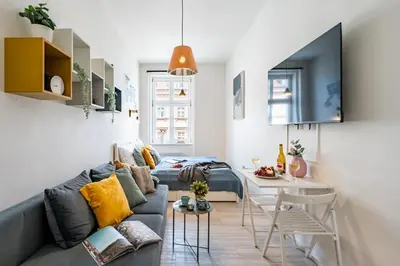 a living room with a couch and a table at Prague Days - Stylish Condo with Netflix in Hip Karlín in Prague