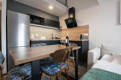 a kitchen and dining room with a table and chairs at CORU House in Prague